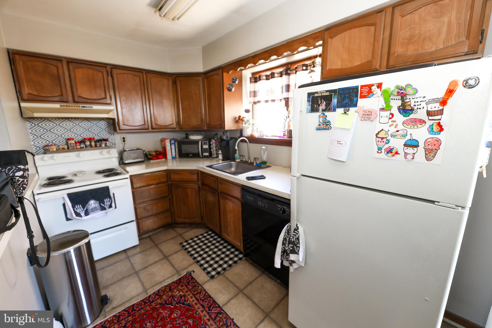 232 Long Lane Upper Darby, PA 19082 - Photo 13 of 29 a white refrigerator freezer sitting inside of a kitchen