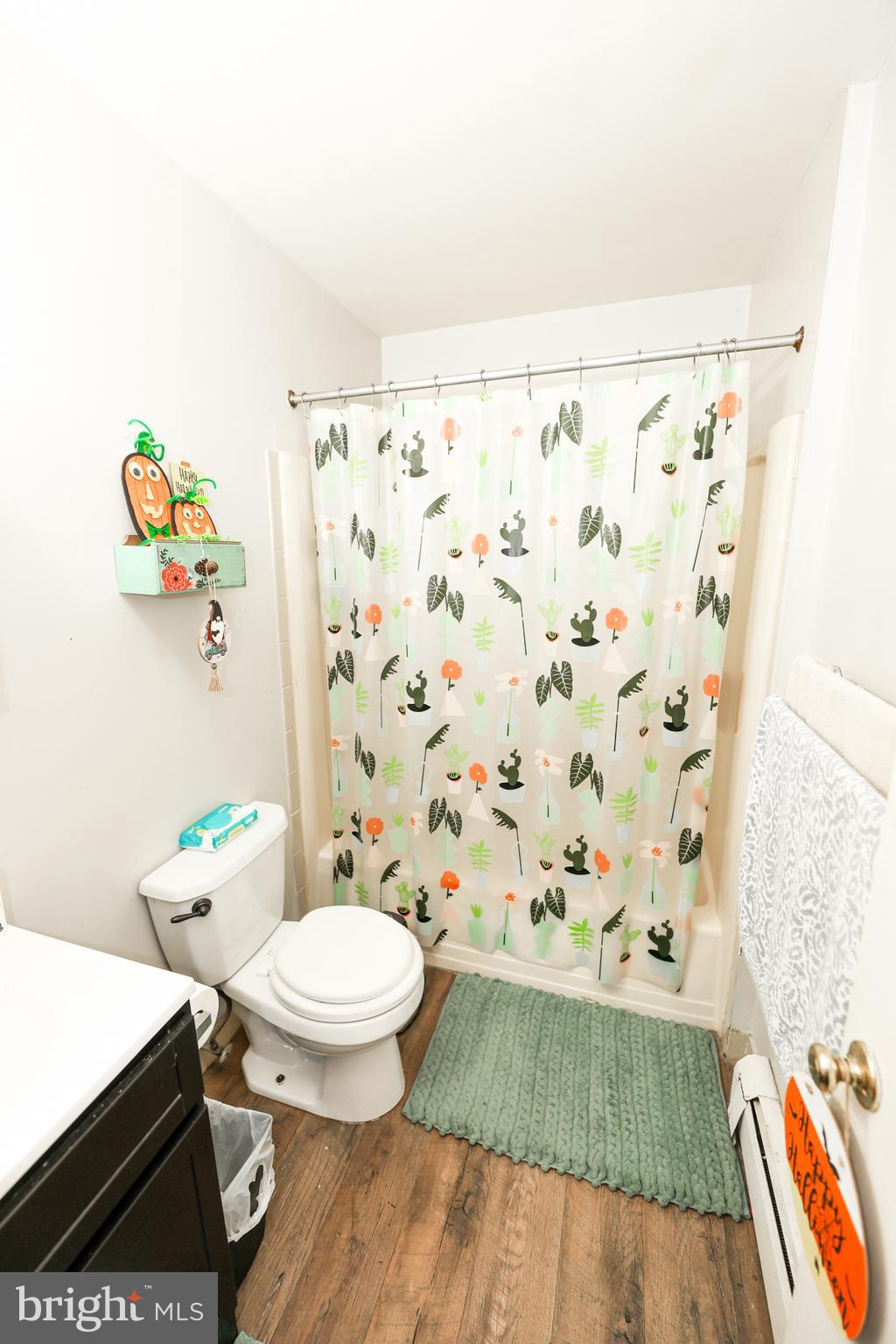 232 Long Lane Upper Darby, PA 19082 - Photo 23 of 29 a bathroom with a toilet and a shower curtain