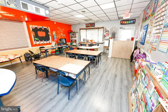 a living room with dining room and wooden floor