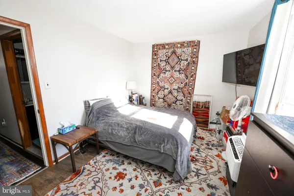 a bedroom with a bed and flat screen tv