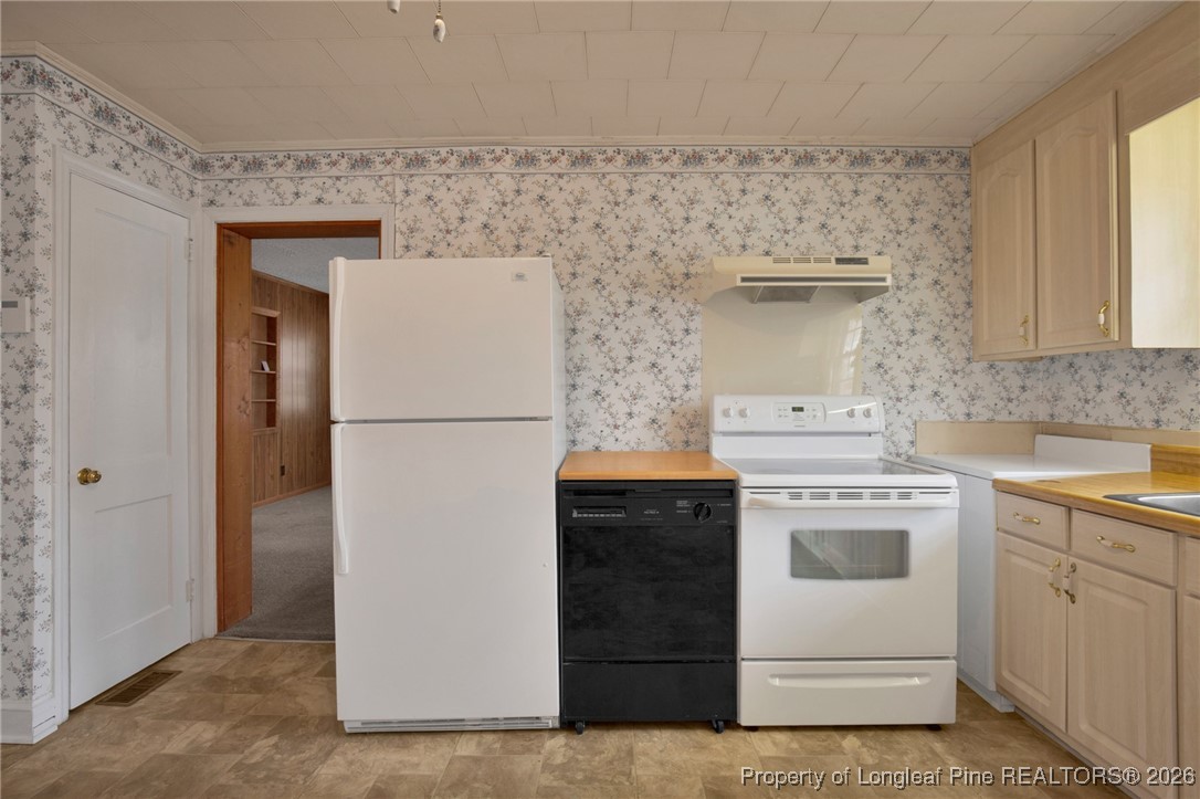 400 Roxie Avenue Fayetteville, NC 28304 - Photo 11 of 33 a kitchen with a stove and a refrigerator
