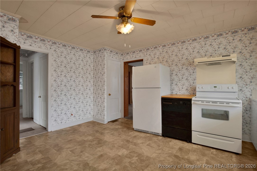 400 Roxie Avenue Fayetteville, NC 28304 - Photo 12 of 33 a kitchen with a stove cabinets and refrigerator