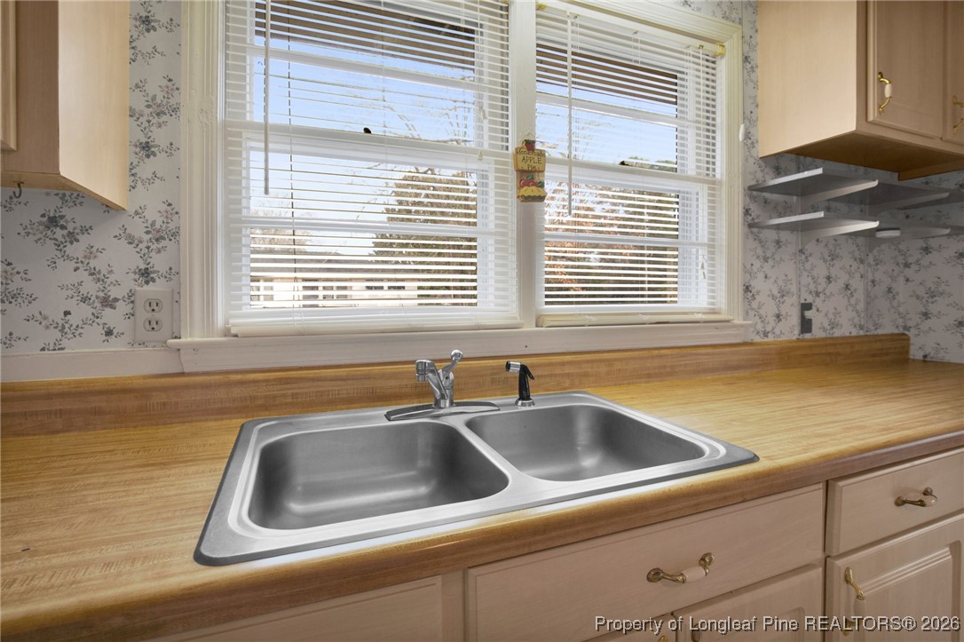 400 Roxie Avenue Fayetteville, NC 28304 - Photo 14 of 33 a view of a sink and dishwasher next to a window