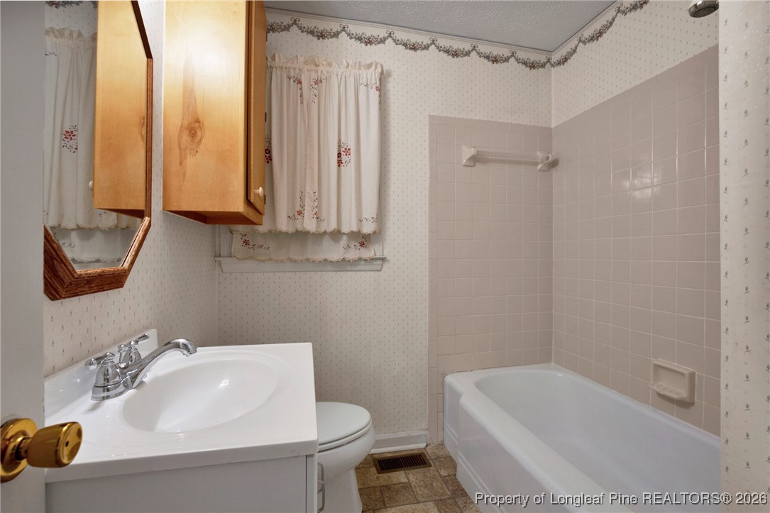 400 Roxie Avenue Fayetteville, NC 28304 - Photo 23 of 33 a bathroom with a sink a toilet and shower