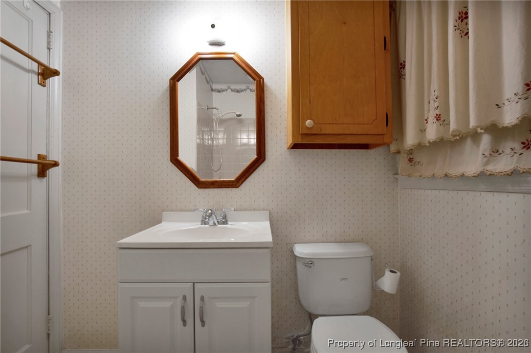 400 Roxie Avenue Fayetteville, NC 28304 - Photo 24 of 33 a bathroom with a toilet sink and mirror