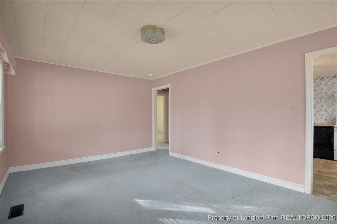 400 Roxie Avenue Fayetteville, NC 28304 - Photo 8 of 33 an empty room with a empty space and windows
