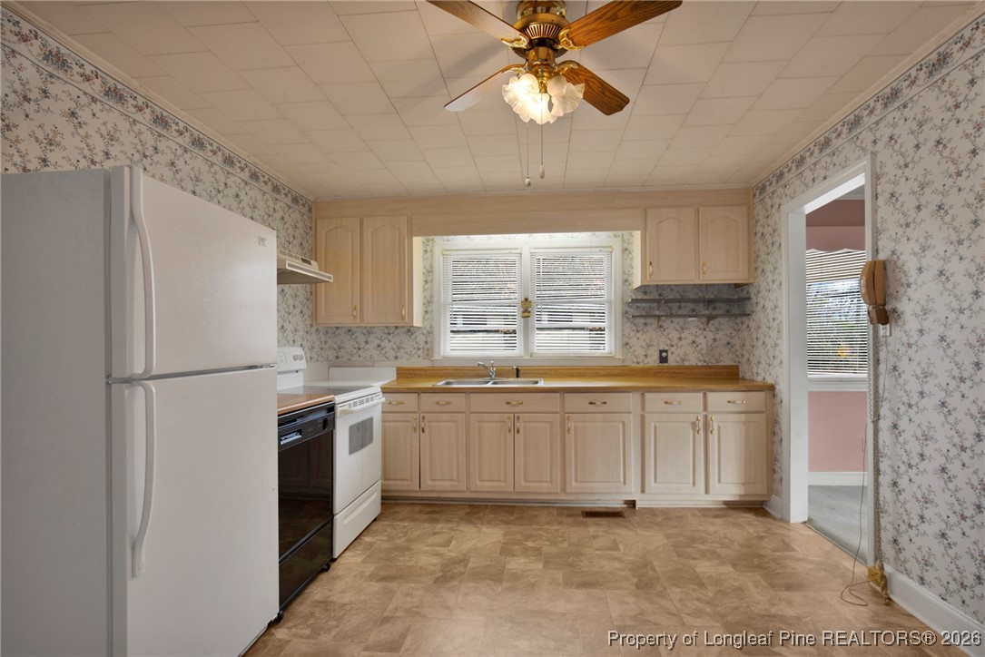 400 Roxie Avenue Fayetteville, NC 28304 - Photo 9 of 33 a kitchen with stainless steel appliances granite countertop a refrigerator a sink a stove a microwave a counter space and cabinets