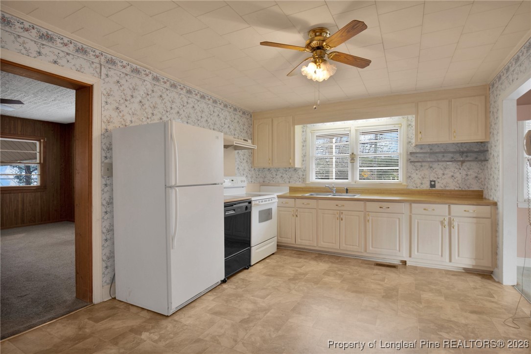400 Roxie Avenue Fayetteville, NC 28304 - Photo 10 of 33 a kitchen with white cabinets and white appliances