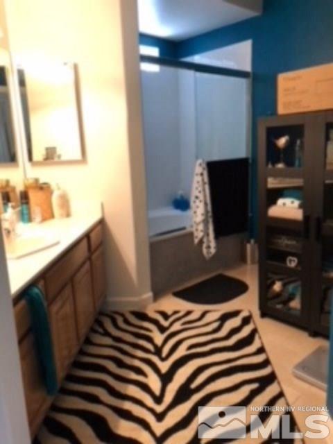900 S Meadows, Unit 5513 Reno, NV 89521 - Photo 11 of 16 a bedroom with a bed and a flat tv screen on the dresser