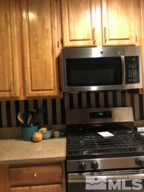 900 S Meadows, Unit 5513 Reno, NV 89521 - Photo 12 of 16 a kitchen with granite countertop a stove and a sink