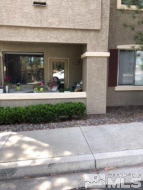 900 S Meadows, Unit 5513 Reno, NV 89521 - Photo 14 of 16 a front view of a house with a yard and a garage