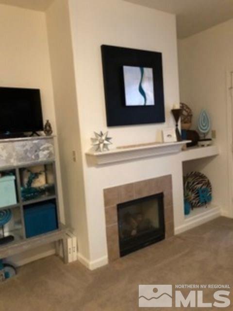 900 S Meadows, Unit 5513 Reno, NV 89521 - Photo 7 of 16 a living room with a fireplace and a flat screen tv