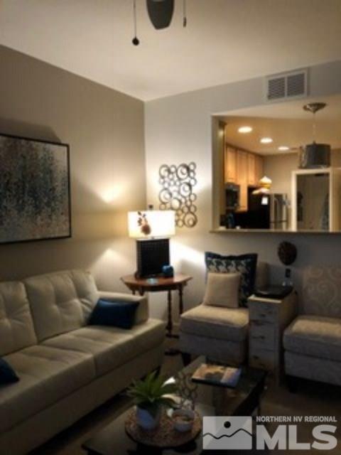 900 S Meadows, Unit 5513 Reno, NV 89521 - Photo 9 of 16 a living room with furniture and a painting on the wall