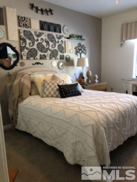 900 S Meadows, Unit 5513 Reno, NV 89521 - Photo 10 of 16 a large bed sitting in a bedroom next to a lamp