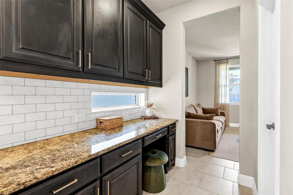 5241 Ranchero Trail Fort Worth, TX 76126 - Photo 11 of 29 a kitchen with granite countertop cabinets washer and dryer