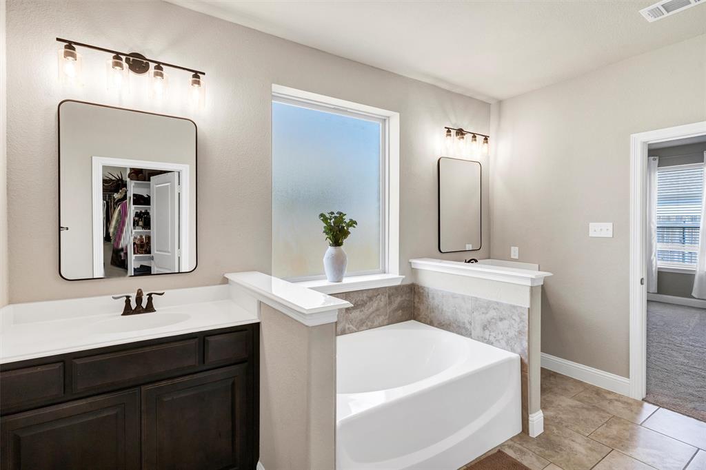 5241 Ranchero Trail Fort Worth, TX 76126 - Photo 18 of 29 a bathroom with a bathtub sink and mirror