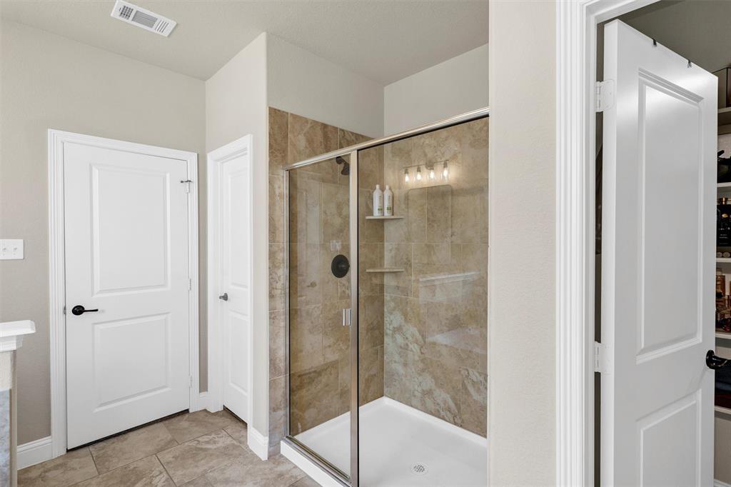 5241 Ranchero Trail Fort Worth, TX 76126 - Photo 19 of 29 a bathroom with a glass shower door
