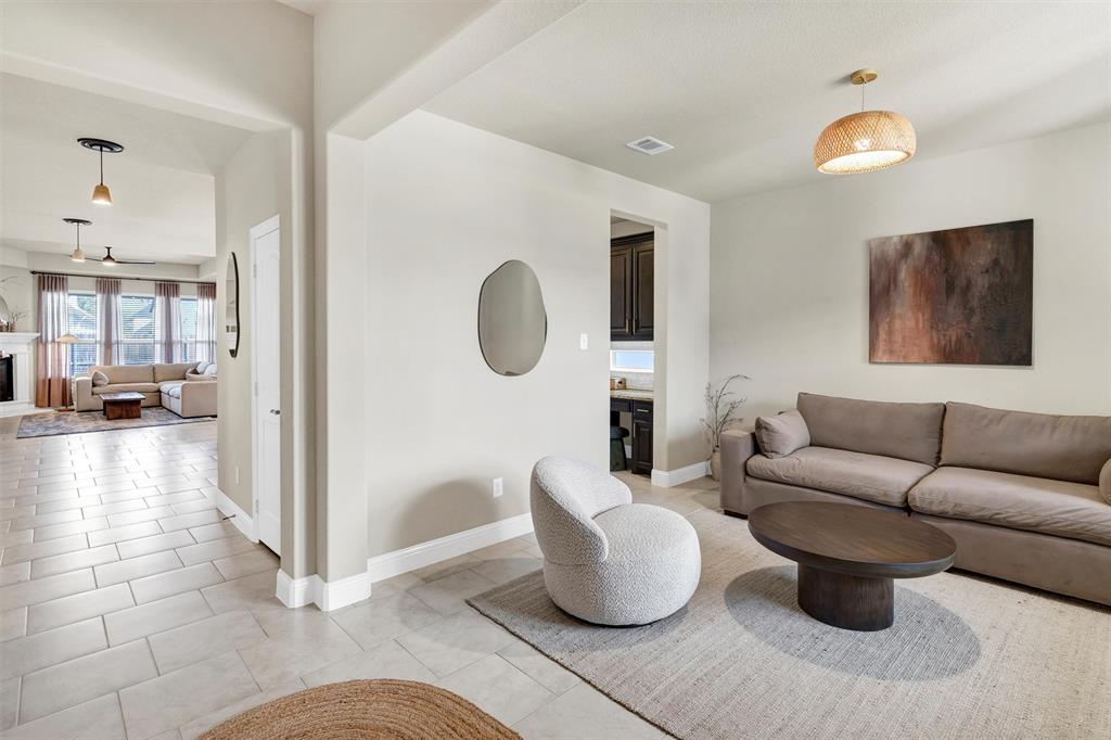 5241 Ranchero Trail Fort Worth, TX 76126 - Photo 6 of 29 a living room with couches a coffee table and kitchen view with wooden floor