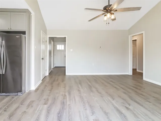 a view of a hallway with wooden floor