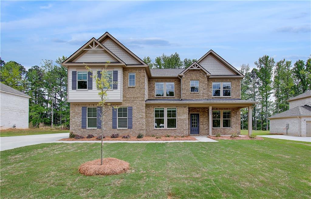 205 Haverling Pass Hampton, GA 30228 - Photo 1 of 1 a front view of a house with a yard