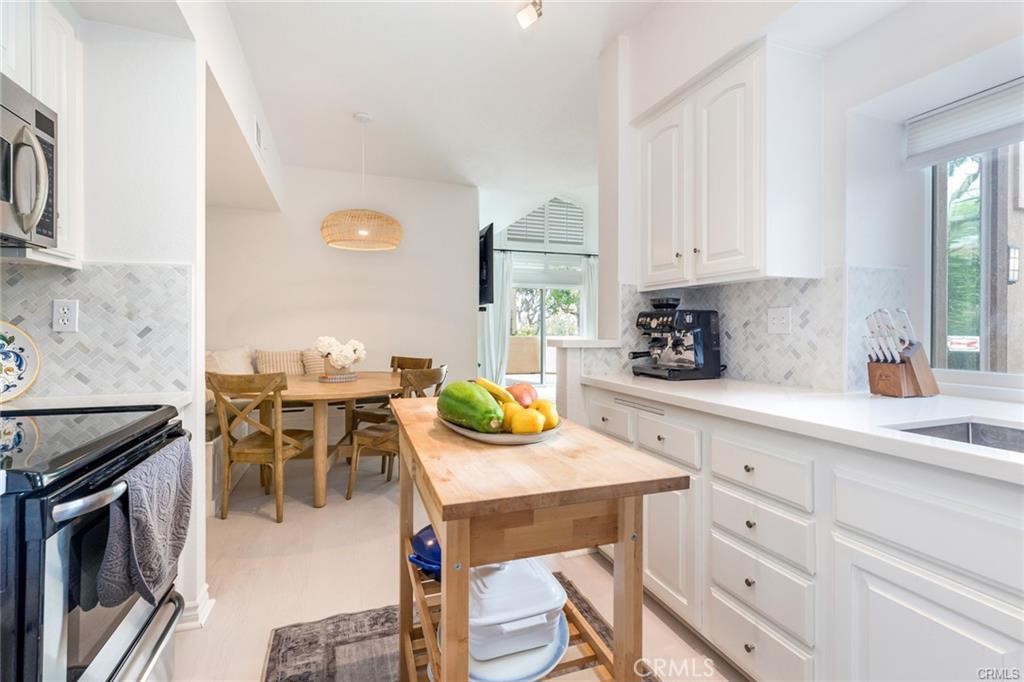 1 Baycrest Place Dana Point, CA 92629 - Photo 11 of 20 a kitchen with a sink and chairs