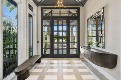 a living room with a couch a flat screen tv and windows