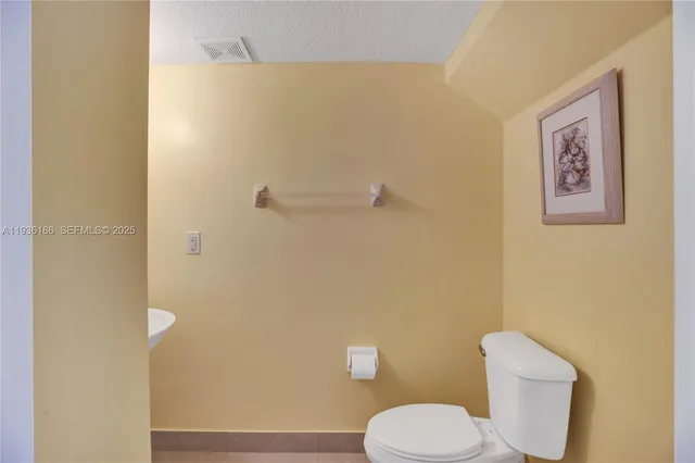 a white toilet sitting next to a bathroom sink