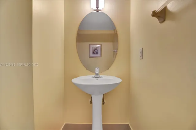 a view of a bathroom with a sink and a mirror