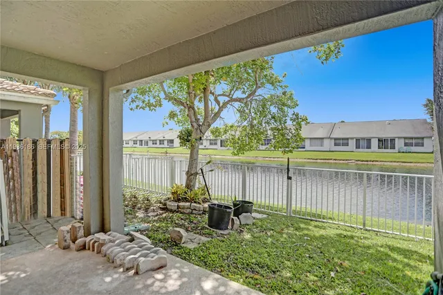 a backyard of a house with lots of green space and seating