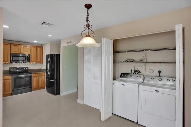 a kitchen with a refrigerator sink and cabinets