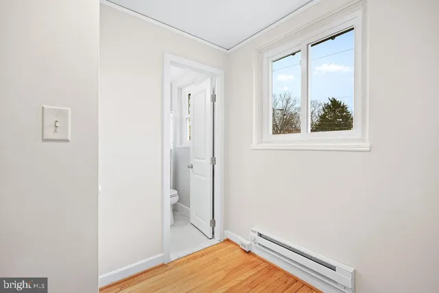 a view of room with window and wooden floor
