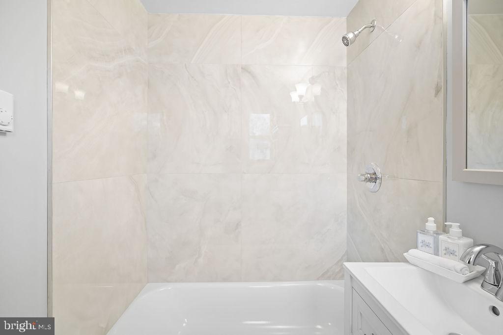 13 Ridge Road Greenbelt, MD 20770 - Photo 13 of 32 a bathroom with a sink and a bathtub