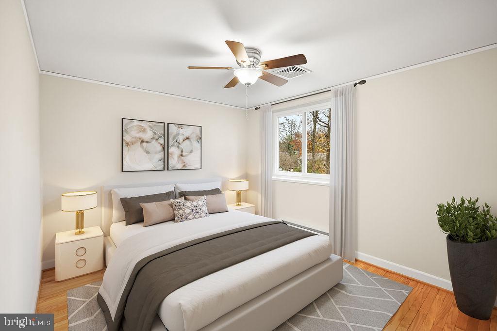 13 Ridge Road Greenbelt, MD 20770 - Photo 15 of 32 a bedroom with a large bed and a window