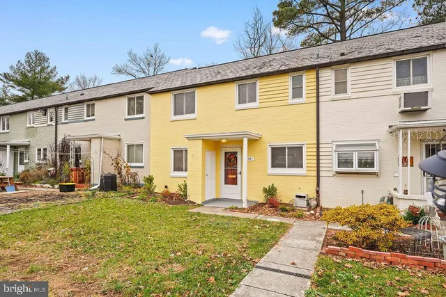 a front view of a house with many windows
