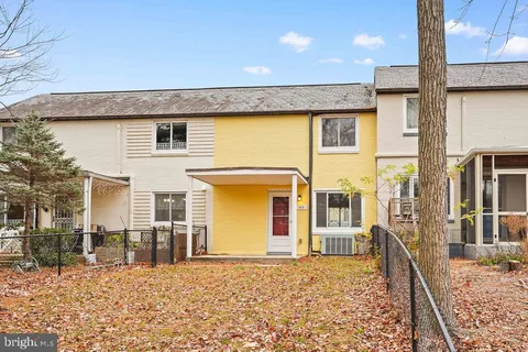 a view of a house with wooden fence
