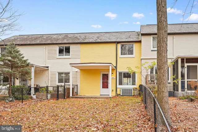 a view of a house with wooden fence