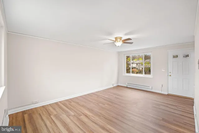 wooden floor in an empty room with a window