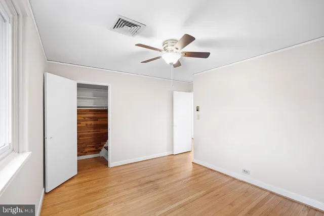 a view of an empty room with wooden floor