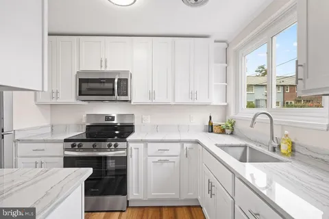 a kitchen with a sink stove and microwave