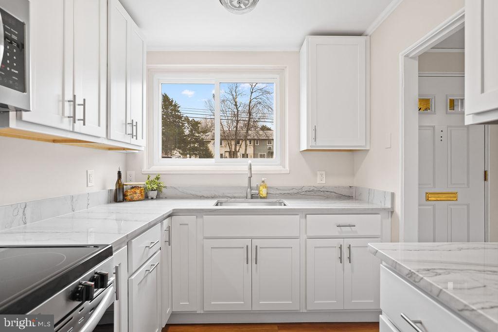 13 Ridge Road Greenbelt, MD 20770 - Photo 6 of 32 a kitchen with granite countertop a sink stainless steel appliances and cabinets