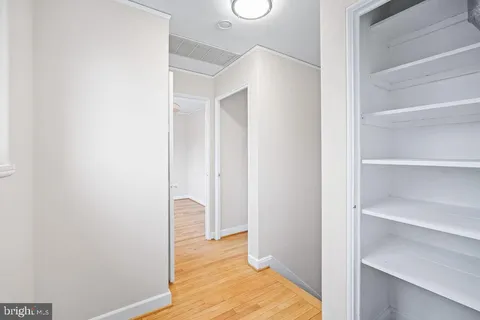 a view of a bedroom with wooden floor and closet
