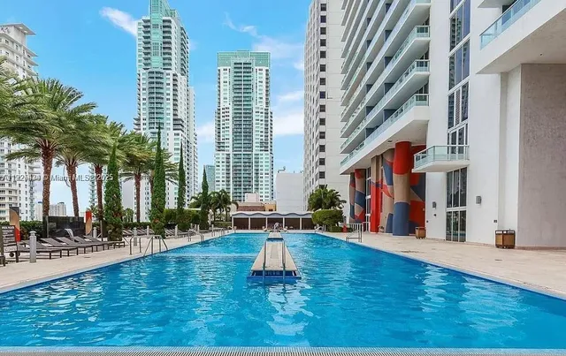 a bedroom with a bed and a night stand