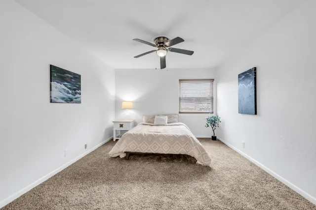 a bed room with a bed and a window