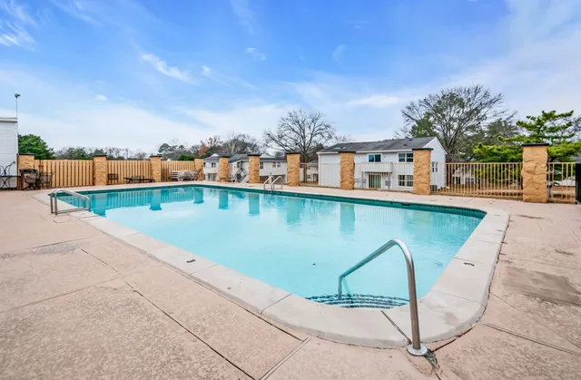 an outdoor view with swimming pool and seating