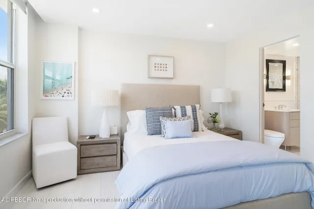 a bedroom with furniture and a large window