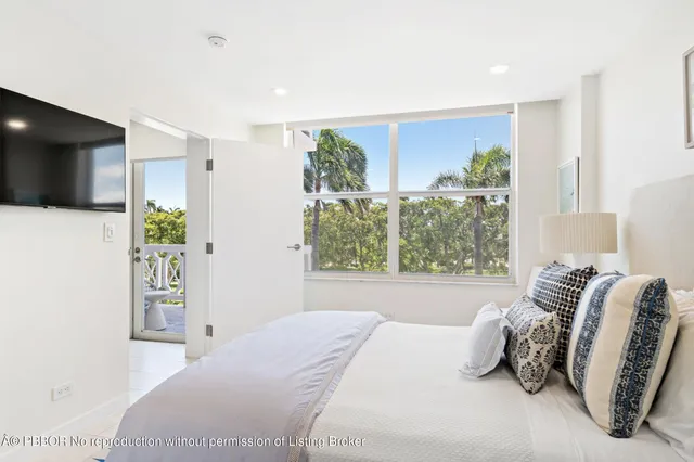 a bedroom with a large bed and a large window