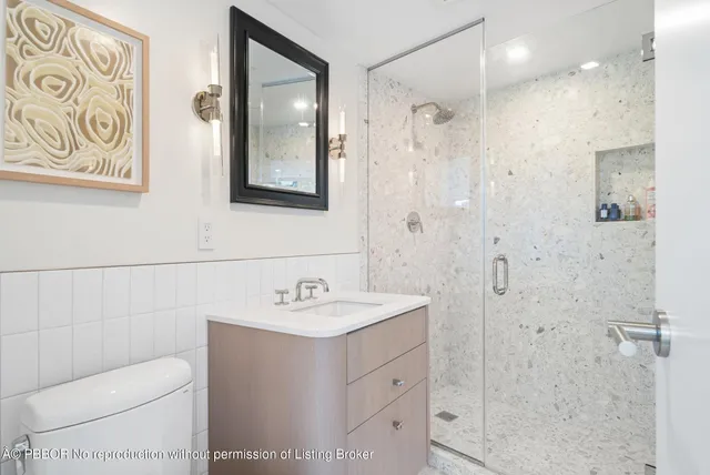 a bathroom with a sink toilet and shower