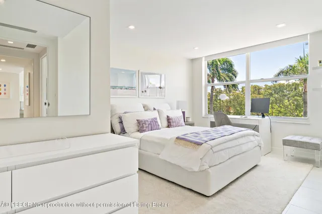 a room with a bed and a large window