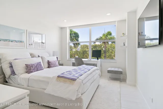 a bedroom with a large bed and a window