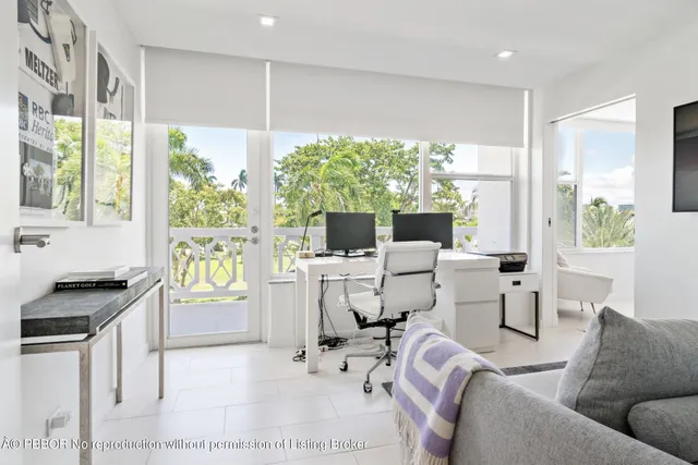 a living room with furniture a large window and a flat screen tv